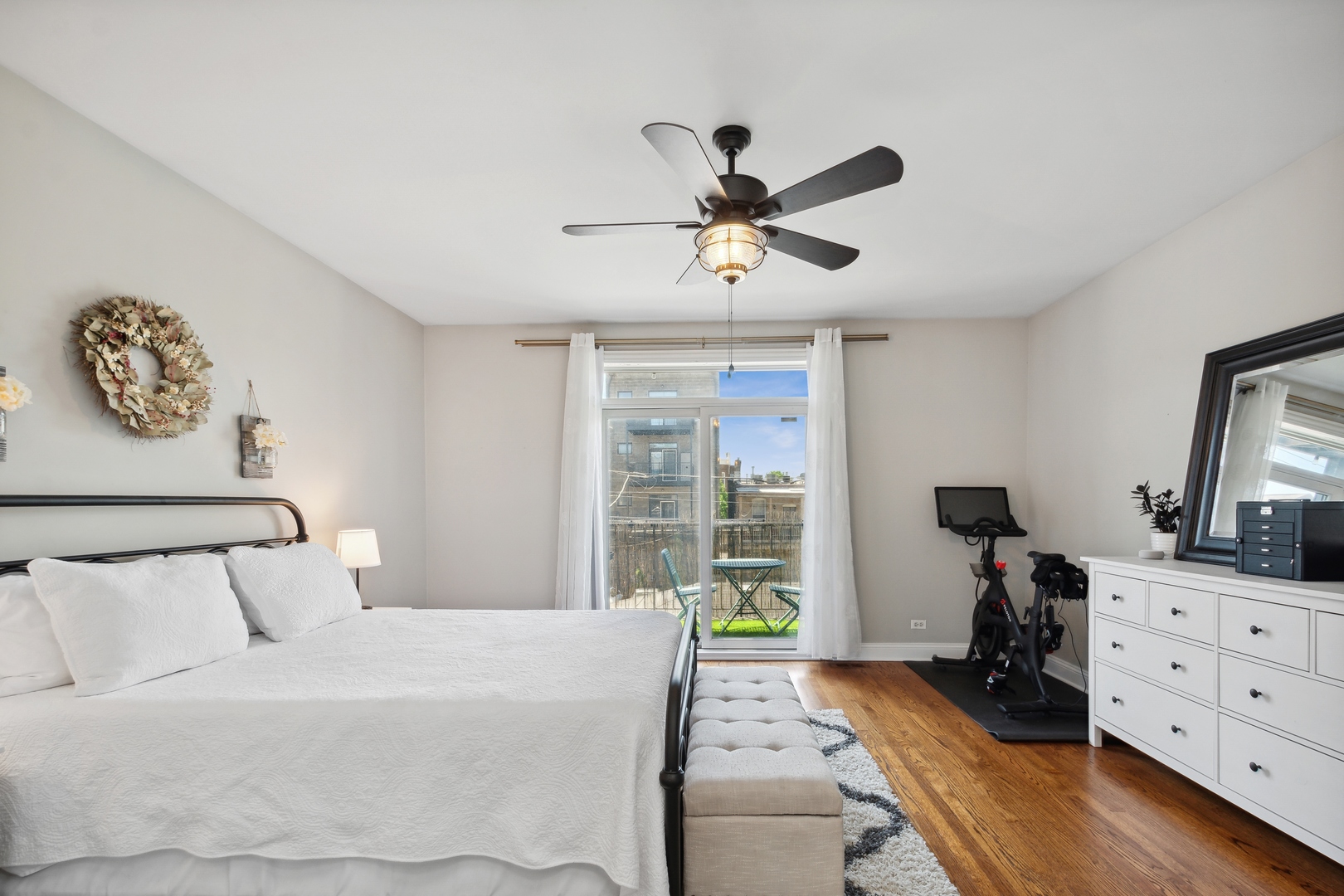 2147 West Rice Street, Unit 2E Chicago, IL 60622 - Photo 9 of 16 a bedroom with a bed and wooden floor