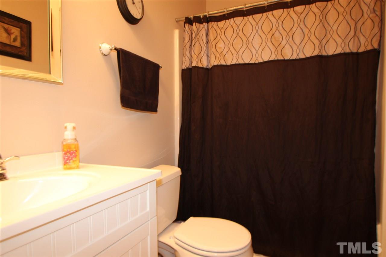 11833 North Exeter Way Raleigh, NC 27613 - Photo 13 of 16 a bathroom with a sink and a toilet