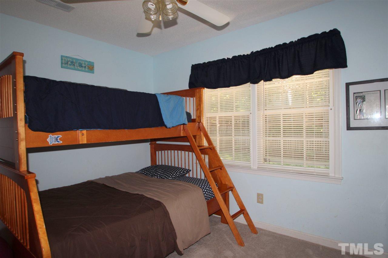 11833 North Exeter Way Raleigh, NC 27613 - Photo 14 of 16 a bedroom with a bed and a window