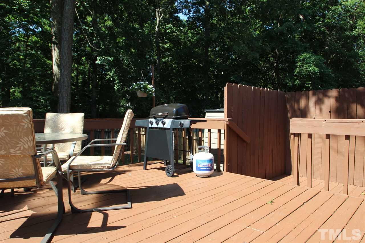 11833 North Exeter Way Raleigh, NC 27613 - Photo 15 of 16 a view of a deck with chair and wooden floor