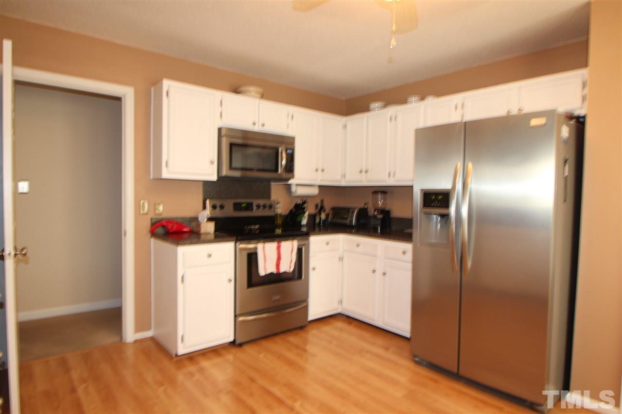 11833 North Exeter Way Raleigh, NC 27613 - Photo 4 of 16 a kitchen with stainless steel appliances a refrigerator sink and microwave