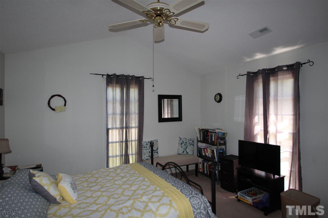 11833 North Exeter Way Raleigh, NC 27613 - Photo 8 of 16 a bedroom with a bed and a window