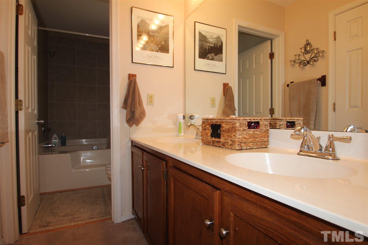 11833 North Exeter Way Raleigh, NC 27613 - Photo 10 of 16 a bathroom with a sink and a mirror