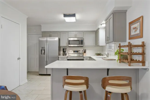 a kitchen with stainless steel appliances a sink and a refrigerator
