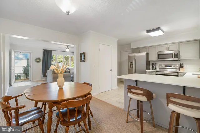 a kitchen with a dining table and chairs