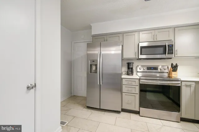 a metallic refrigerator freezer and a stove top oven