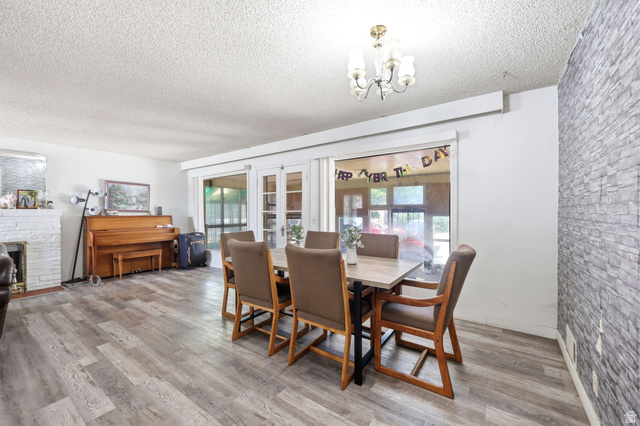 5480 South 2000th Street West Roy, UT 84067 - Photo 17 of 36 Spacious dining area featuring wood-finish flooring and a stone accent wall