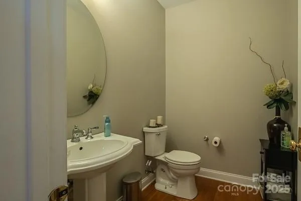 a bathroom with a sink and mirror with toilet
