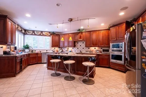 a kitchen with granite countertop counter top space a sink stainless steel appliances and cabinets