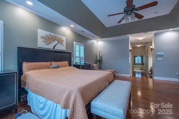 a bedroom with bed and wooden floor