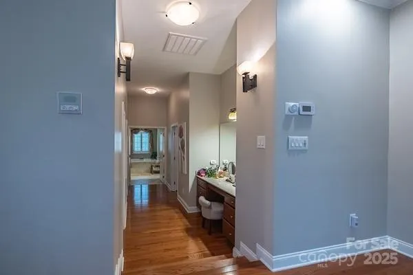 a view of a hallway with wooden floor windows and livingroom