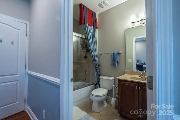 a bathroom with a toilet a sink and shower