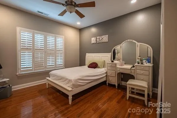 a bed room with a bed and a chair