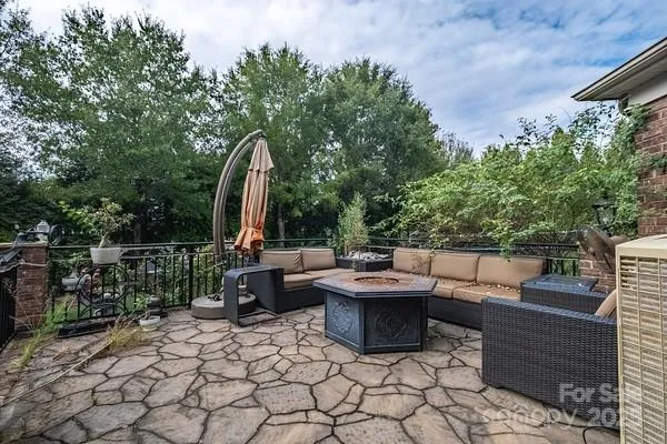 a view of a patio with table and chairs and potted plants