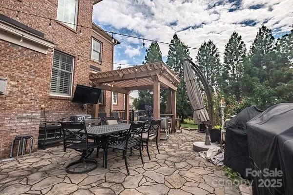 a view of a backyard with plants and a patio