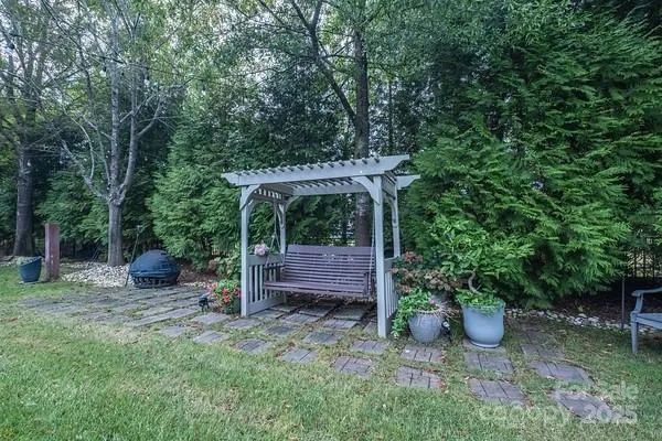 a view of a backyard with a wooden fence