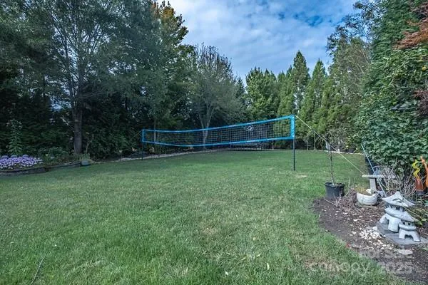 an aerial view of a house with a yard and lake view