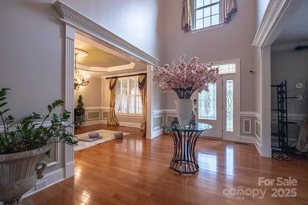 a dining room with furniture potted plants and wooden floor
