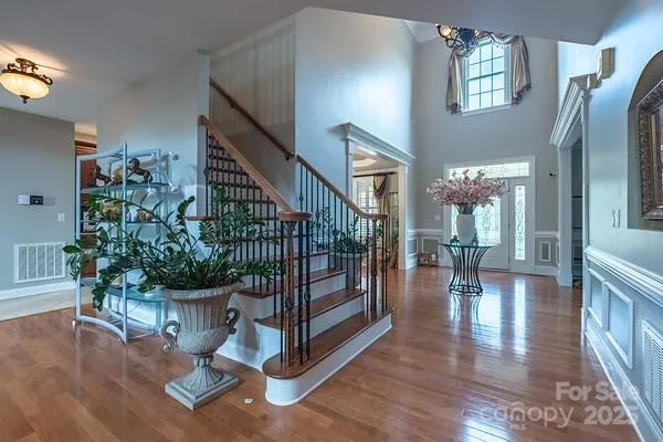 a view of entryway livingroom and hall with wooden floor