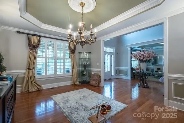 a living room with furniture and a chandelier
