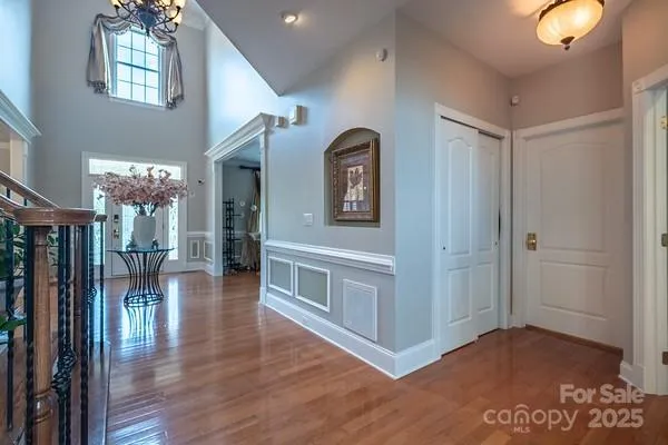 a view of a hallway with entryway wooden floor and front door