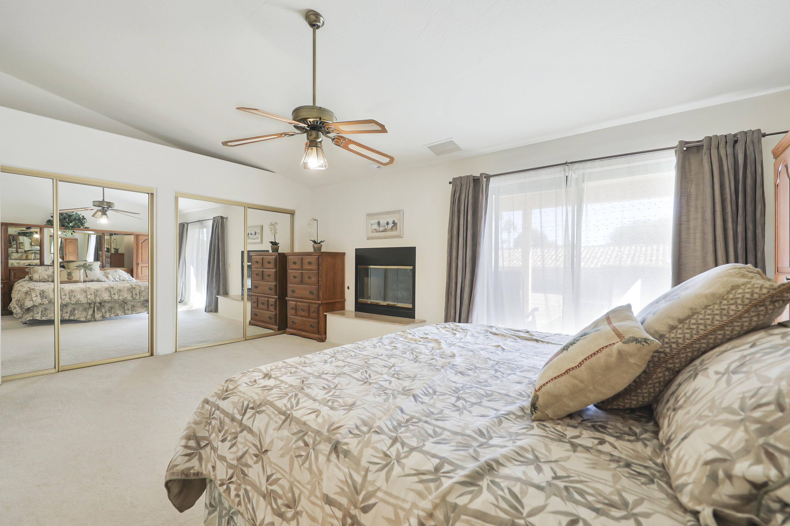 79170 Starlight Lane Bermuda Dunes, CA 92203 - Photo 14 of 33 a spacious bedroom with a large bed and a chandelier
