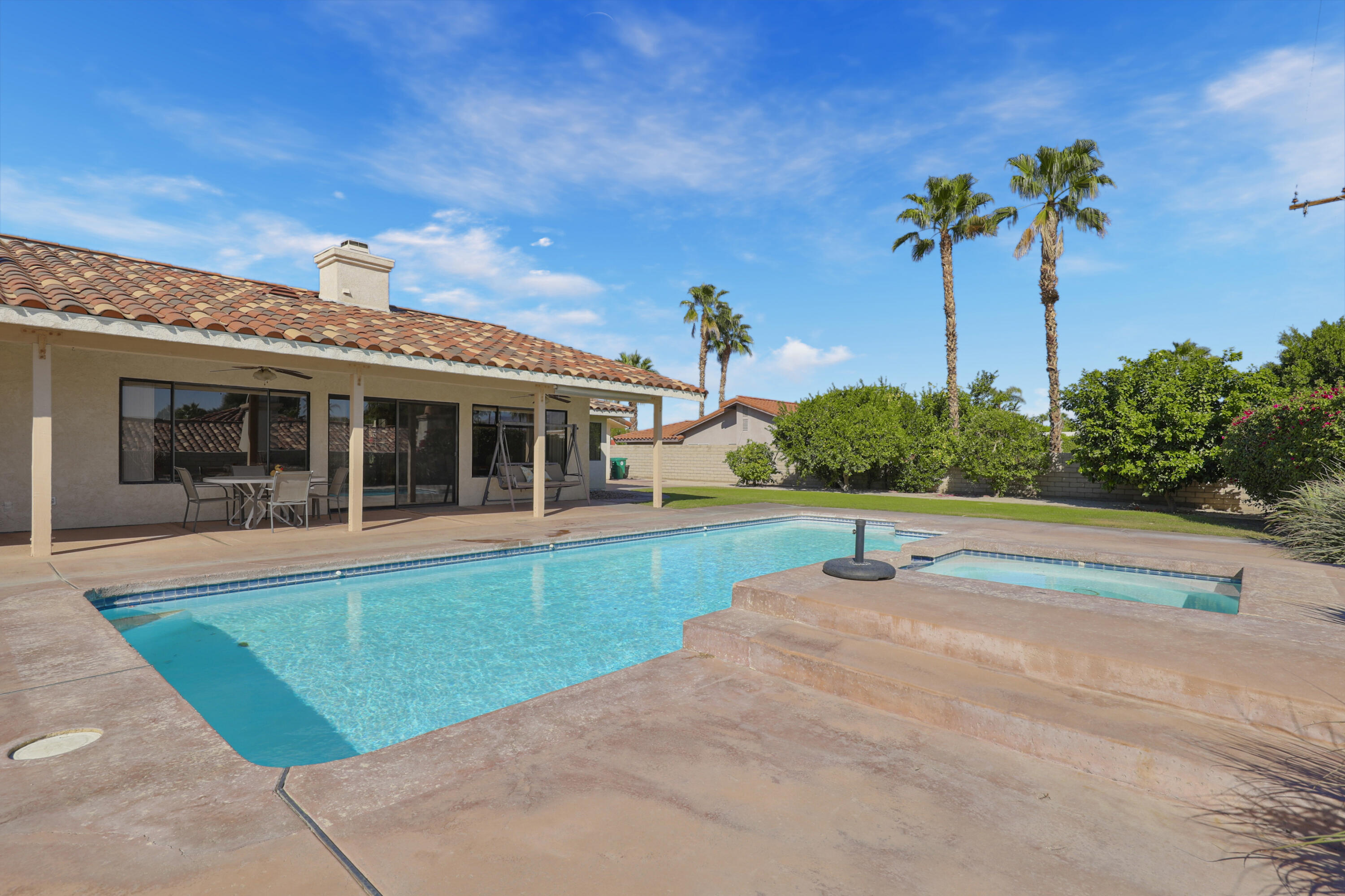 79170 Starlight Lane Bermuda Dunes, CA 92203 - Photo 26 of 33 a view of a house with a swimming pool and a yard