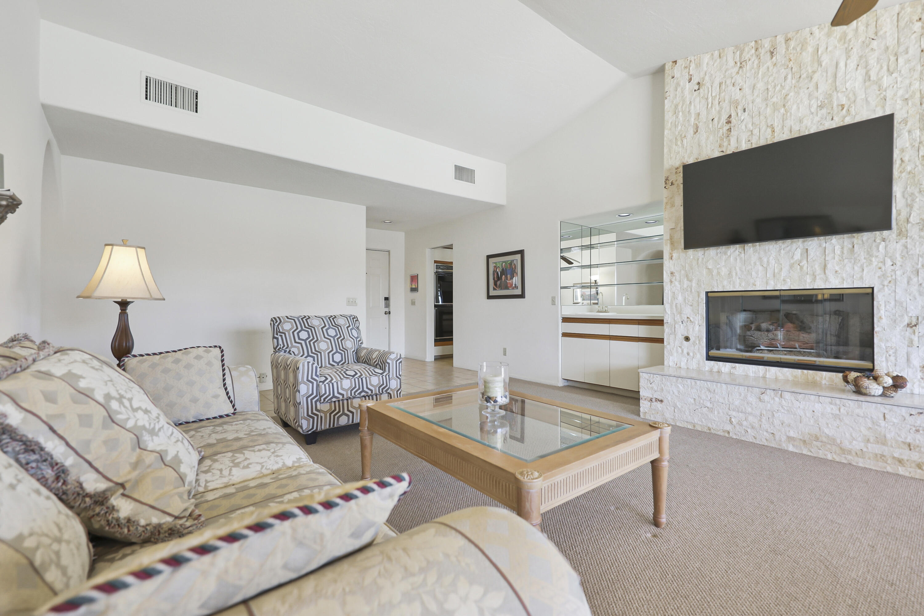 79170 Starlight Lane Bermuda Dunes, CA 92203 - Photo 3 of 33 a living room with furniture a flat screen tv and a fireplace