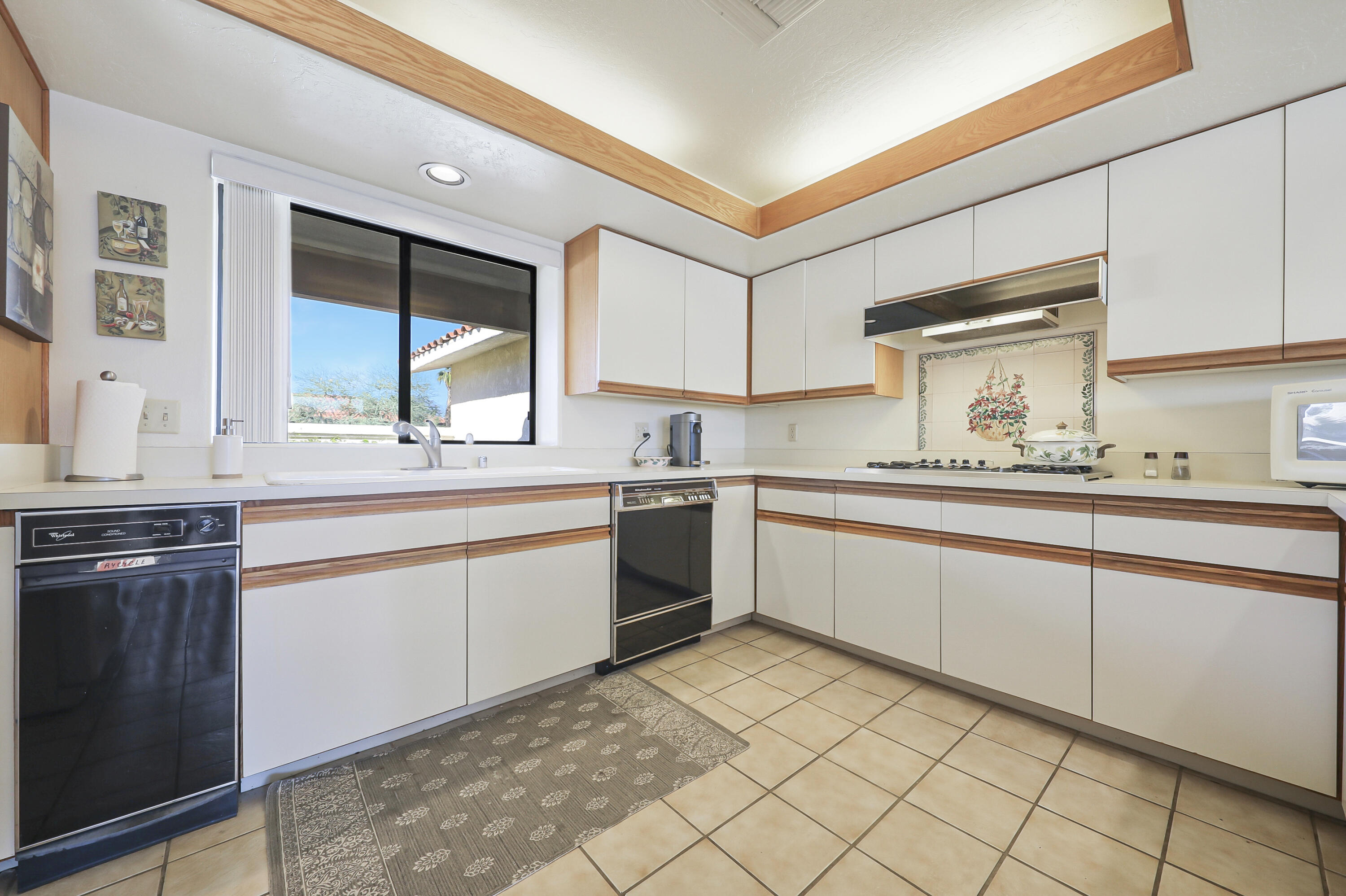 79170 Starlight Lane Bermuda Dunes, CA 92203 - Photo 6 of 33 a kitchen with granite countertop white cabinets and white appliances