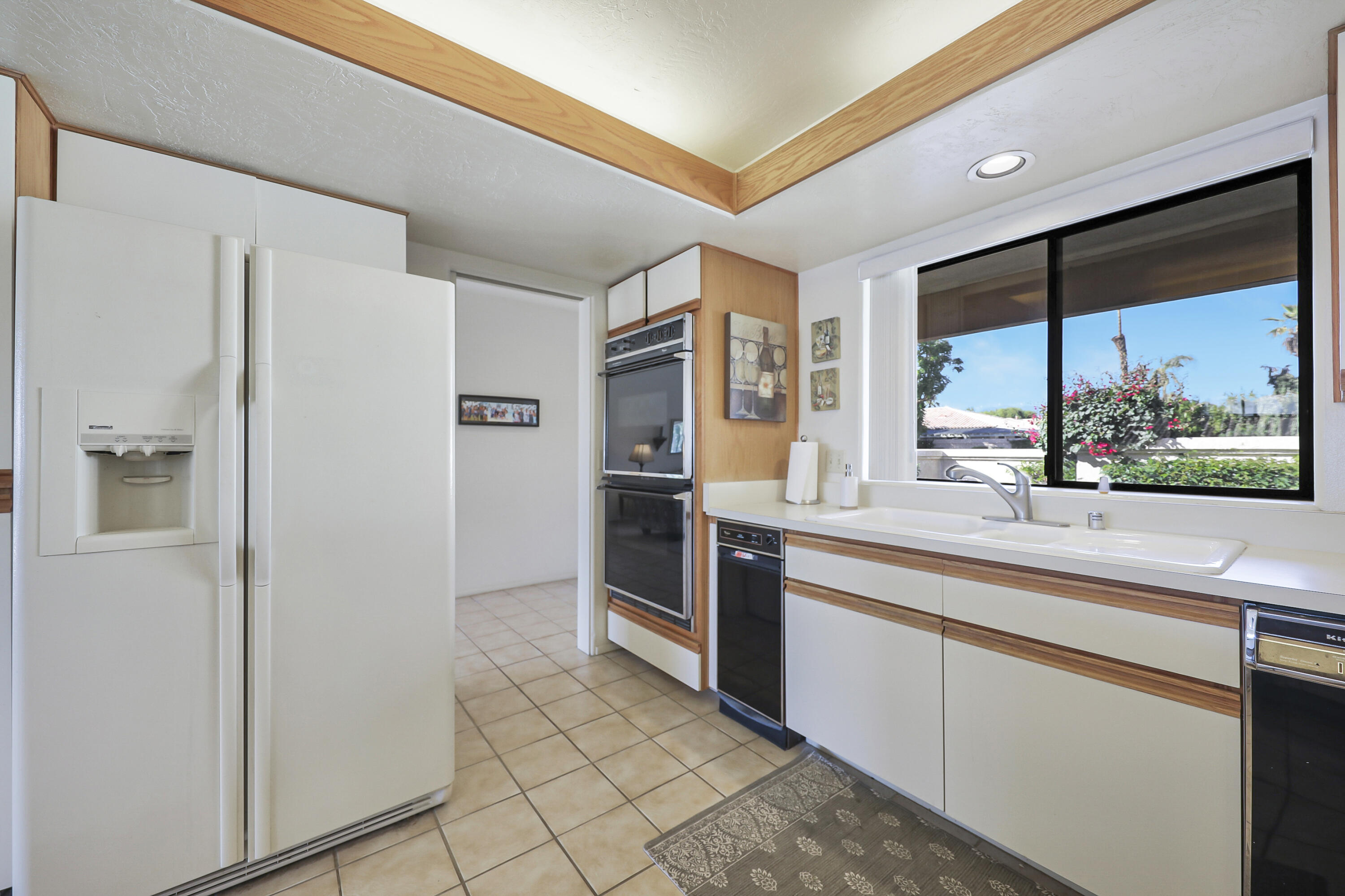 79170 Starlight Lane Bermuda Dunes, CA 92203 - Photo 8 of 33 a kitchen with stainless steel appliances a sink and a large window