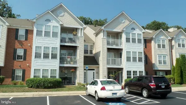 a front view of a residential apartment building with a yard