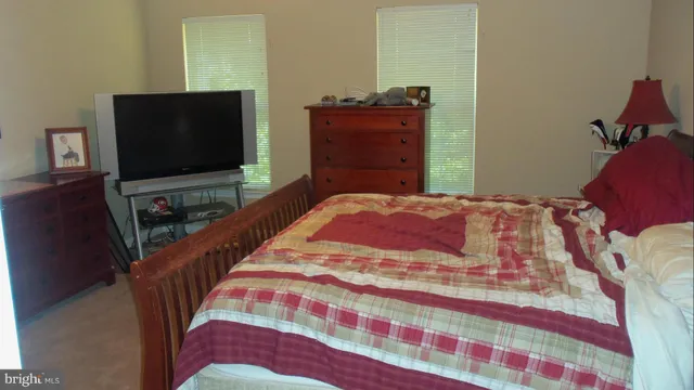a bedroom with a bed and flat screen tv