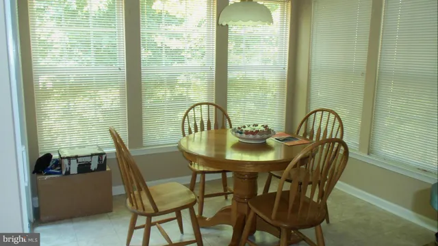 a view of a dining room with furniture and window