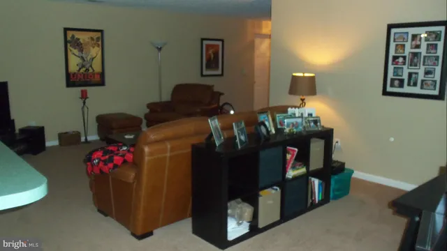 a living room with furniture and baby bed