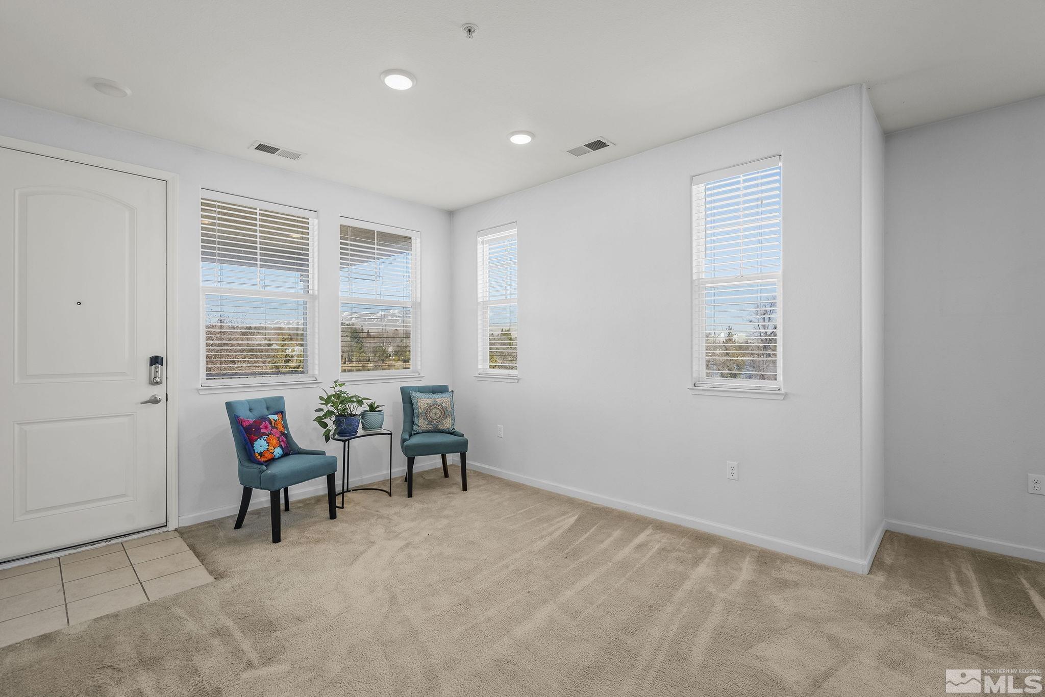 2490 Eastshore Place, Unit 401 Reno, NV 89509 - Photo 5 of 19 a view of living room filled with furniture and windows