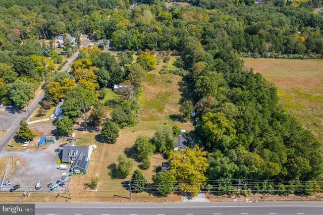 an aerial view of a residential houses with yard