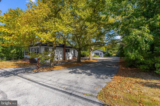 a view of a house with garden and sitting area