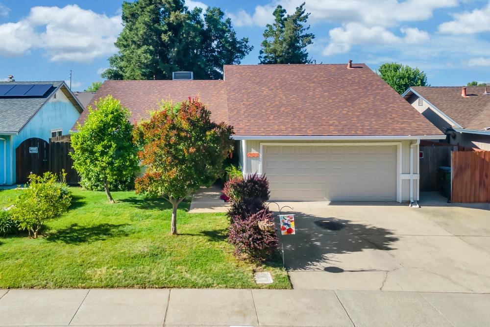 227 Donner Drive Lodi, CA 95240 - Photo 1 of 1 a front view of a house with a garden and plants