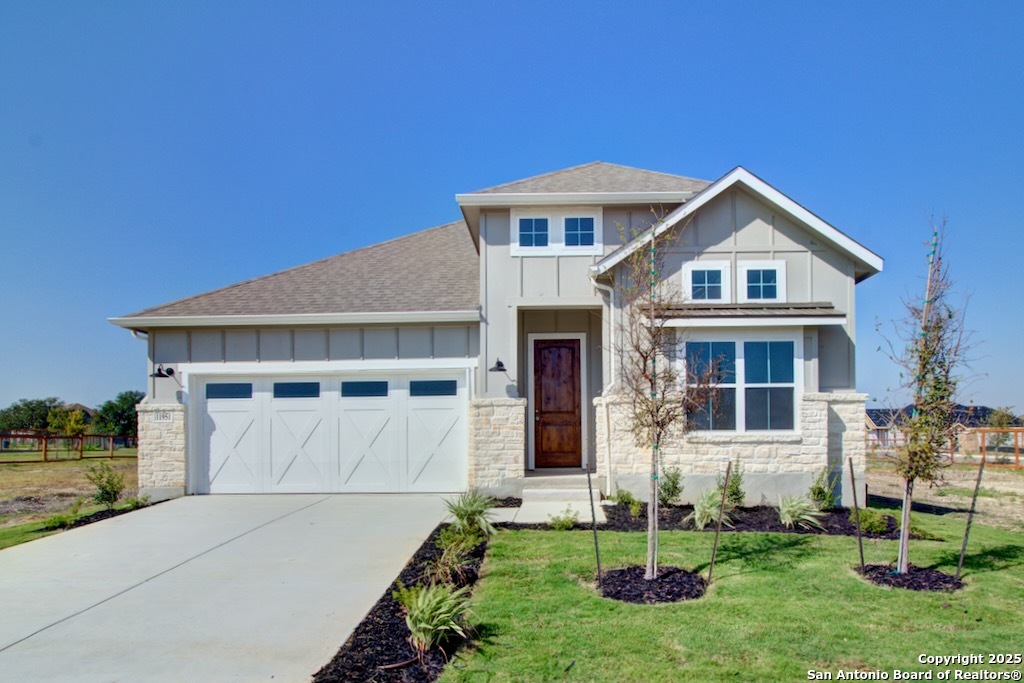 a front view of a house with a yard and garage