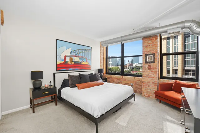 a bedroom with a bed and glass window
