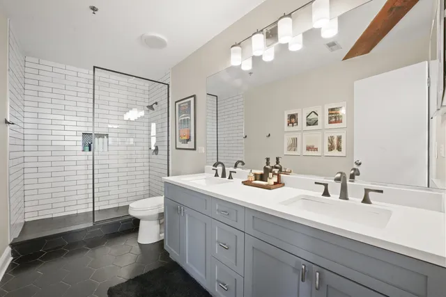 a bathroom with a sink a toilet and shower