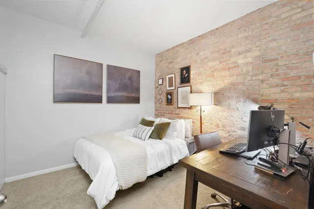 a bedroom with a bed and a desk