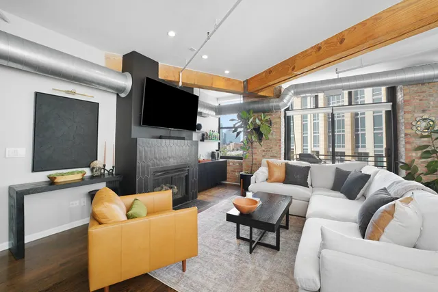 a living room with fireplace furniture and a flat screen tv