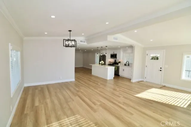 a view of a room with wooden floor and window