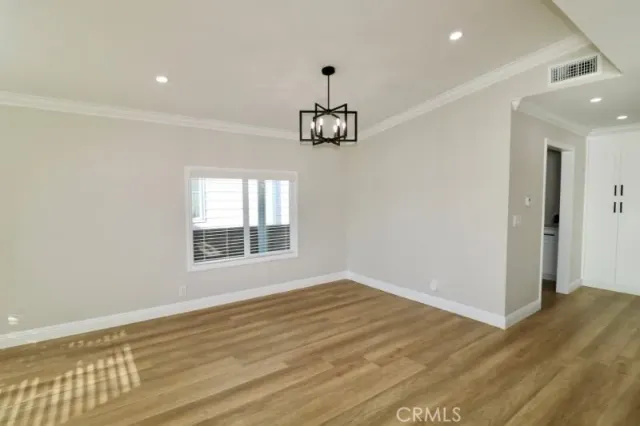 a kitchen with cabinets and wooden floor