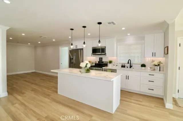 a spacious bathroom with a granite countertop sink a mirror and shower