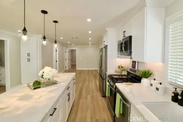 a kitchen with a sink stove and cabinets