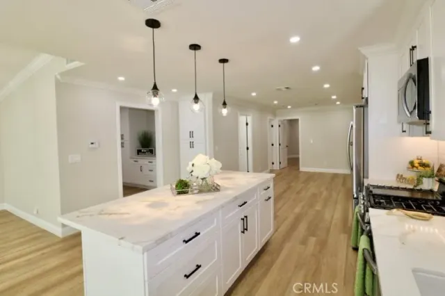 a kitchen with stainless steel appliances a stove microwave and a refrigerator