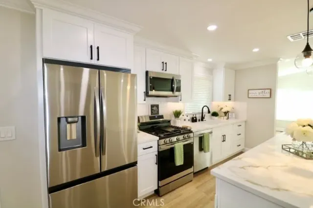 a bathroom with a granite countertop sink a toilet a large mirror and shower