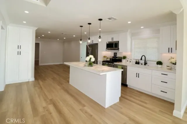 a view of an empty room with window and a ceiling fan